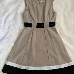 Elegant Beige Sleeveless Dress with Black Accents